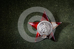 Red Star order on green background, Russia. Old Russian military medal