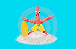 Red starfish surfer posing on blue