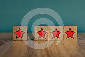 Red stars on wooden cubes on a blue background. Stars mean assessing quality. five-point rating system