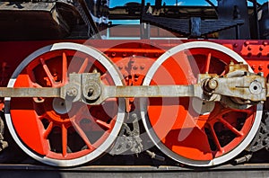 Red steam locomotive wheels, metal wheels of an old steam locomotive