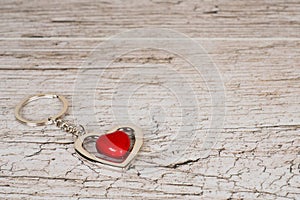 Red steel heart keyring on wooden table