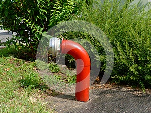 Red steel pipe fire hydrant with aluminum cap