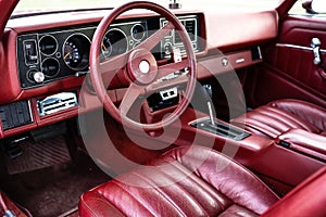 red steering wheel, dashboard of an old powerful classic American car