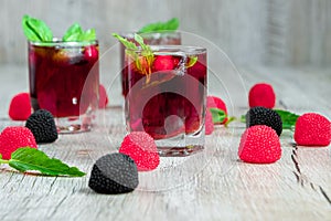 Red stemware shot alcoholic cold cocktail with cranberries raspberries lemon and mint. Selective focus, copy space