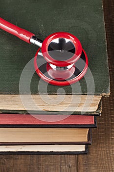 Red Stethoscope on Books Pile