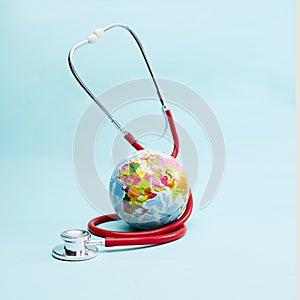 Red Stethoscope on bright pastel blue background