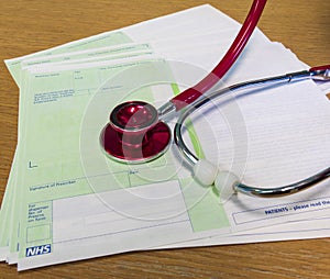 Red stethoscope and prescriptions in a doctor surgery