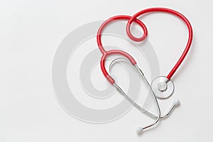 Red Stethoscope in Shape of Heart On White Background.