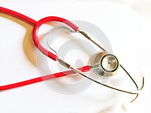 Red stetoscope with white background