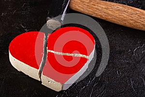 Red stone heart broken by hammer
