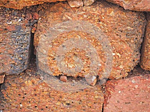 red stone wall of porous volcanic bricks rough surface texture