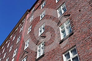 Red stone white windows building house in streets of Helsinki european city