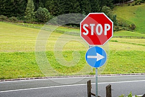 Red stop sign near a forest