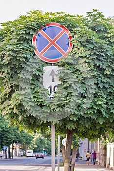 Red stop sign with trees