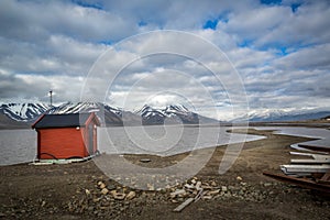 Red storage house next to the Greenland Sea