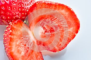 Red strawberries closeup on white dish, background