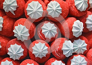 Red strawberries made with colorful sugar for sale in candy shop