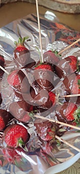 Red strawberry in black chocolate