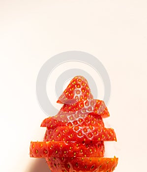 Red strawberry cut to recreate a tree on a white background. Healthy food concept photo