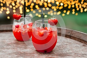 Red strawberry daiquiri cocktail or mocktail in glass with drinking straw. Refreshing summer drink for party or festive