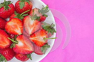 red strawberry food background a sweet red fruit a half plate of red berry heart-shaped fruits on pink cloth texture