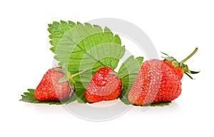 Red strawberry fruits with green leaves