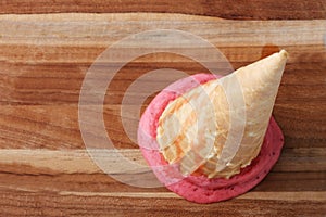 Red strawberry ice cream cone dropped melt