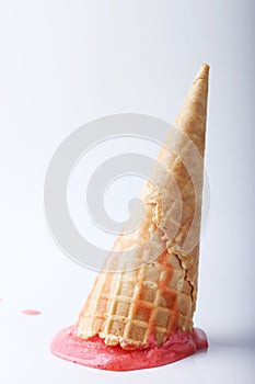 Red strawberry ice cream cone dropped melt