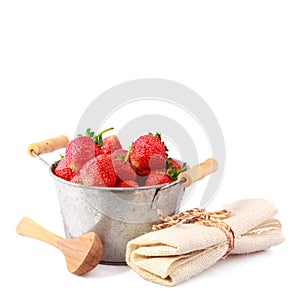 Red strawberry in iron bucket on isolated white background