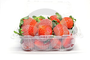 Red strawberry ripe sweet fruit in plastic box packaging