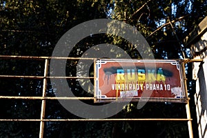 Red street sign Ruska - translation:Russian - is painted over with blue and yellow color as Ukrainian flag in Prague