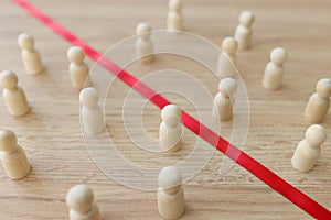 Red strip divides wooden figurines of opponents on table