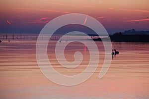 Red stripe in the sky reflected in the sea