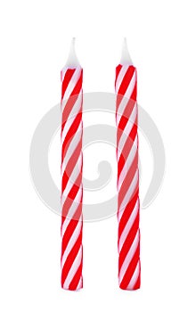 Red striped birthday candles on white