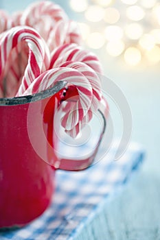 Red striped candy canes in a red mug
