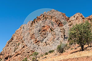 Red structural rock against the blue sky in the mountains of Armenia.