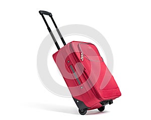 Red suitcase on wheels with the handle extended in the running position, isolated on white background.