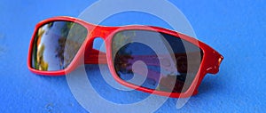 Red Sun Glasses Visual Wear Fashion on Blue Background