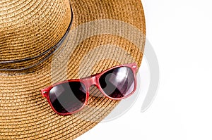 Red sunglasses and beach hat isolated on white