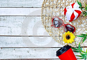 Red sunglasses heart shape, coffee cup, yellow flower