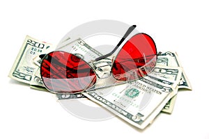 Red sunglasses resting on cash