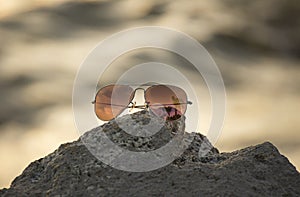 Red sunglasses on the rock, focus sunglasses