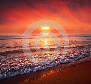 red sunset on beach with big sun