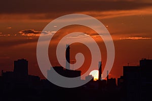 Red sunset over the city silhouette