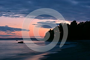 Red sunset over the coast and the sea and pink