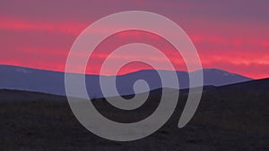 Red sunset over the tops of large sand dunes. Great Sand Dunes National park. COLORADO. USA