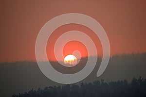 Red Sunset and smoke haze over Buxton Victoria