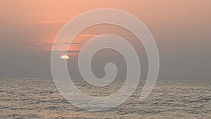 Red sunsets over sea video. The sun touches horizon. Red sky, yellow sun and amazing sea. Summer sunset seascape. Atlantic Ocean b