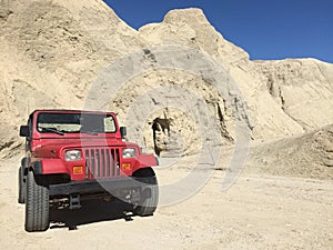 Red SUV Parked by Arroyo Tapiado Mud Caves in Anza Borrego State Park photo
