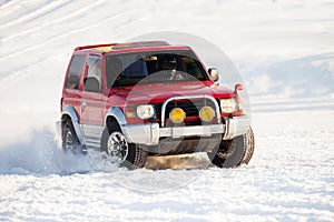 Red SUV rally race at frozen river in winter